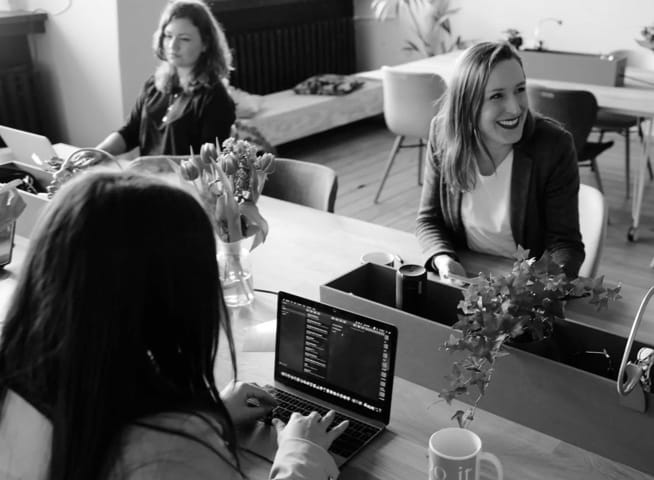 Three White Females having a business Meeting